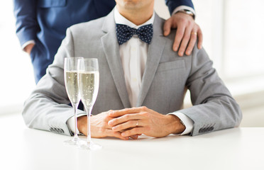 close up of male gay couple with champagne glasses