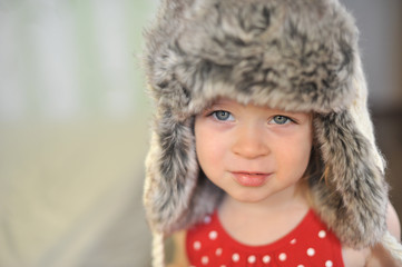 baby with blue eyes in the cap