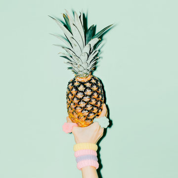 Fashion photo. Hand holding pineapple. vanilla style