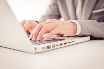 Closeup of businessman hands typing on laptop computer