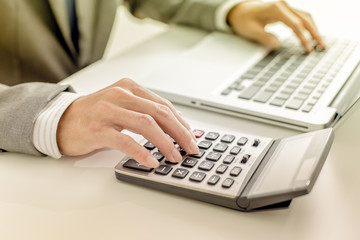 Closeup of businessman hands typing on laptop computer