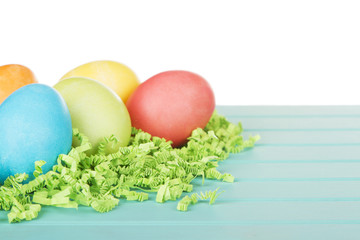 Dyed Easter eggs on green confetti