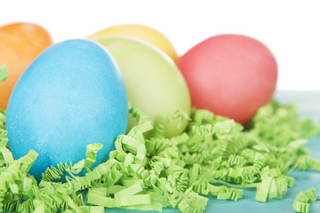 Dyed Easter eggs on green confetti