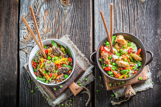 Beef, chicken in sesame seeds with noodles and vegetables