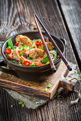 Traditional asian dish with chicken with sesame and noodles