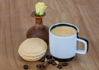 Coffee with macaroons and rose