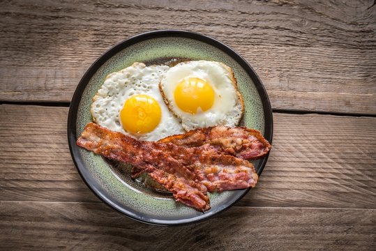 Portion of fried eggs with bacon