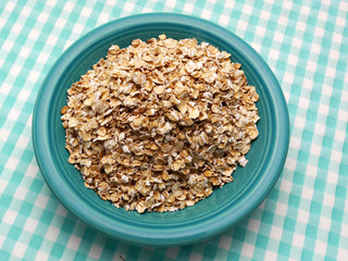 Uncooked oatmeal in a blue bowl