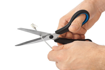 Hand with scissors and phone cable