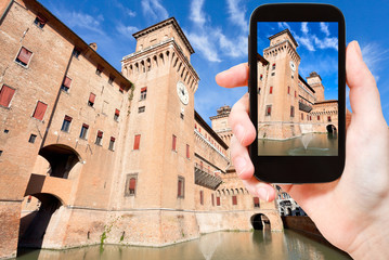 tourist taking photo of Castle Estense in Ferrara