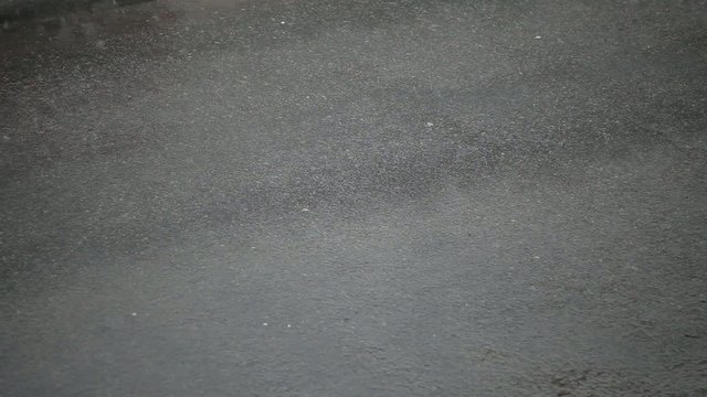 on the pavement snow falls