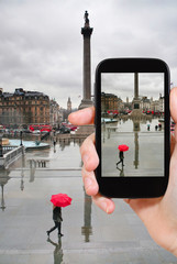 tourist taking photo of trafalgar square