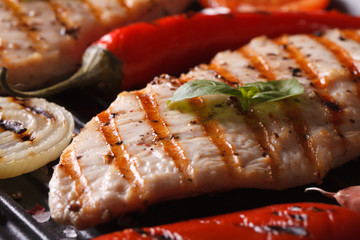 Delicious chicken with peppers and onions in a pan grill macro