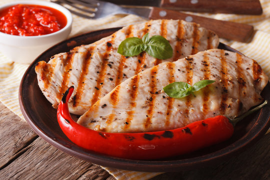 Grilled chicken fillet with chili peppers and sauce. Horizontal