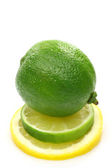 one whole lime fruit on top of a slice lime and lemon 