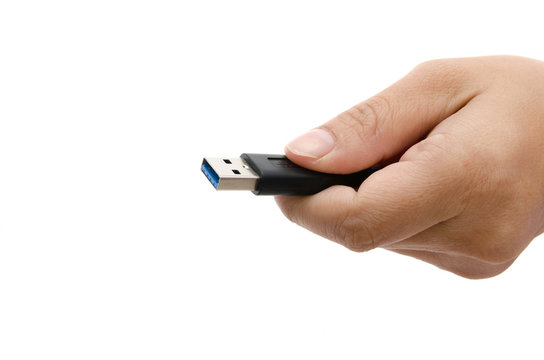 Hand holding black USB data storage