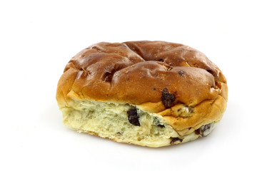 freshly baked current bun (krentenbol) on a white background