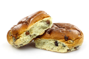 freshly baked current buns (krentenbol) on a white background