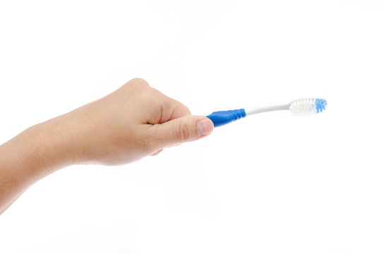 Hand holding toothbrush