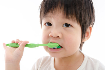 Cute asian bay brushing teeth on white background