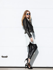 Young beautiful fashionable woman posing outdoors