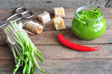 Ramson and sauce pesto on a wooden table