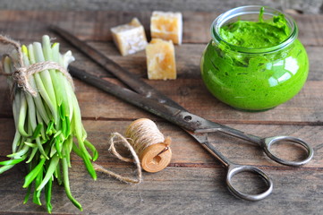 Ramson and sauce pesto on a wooden table