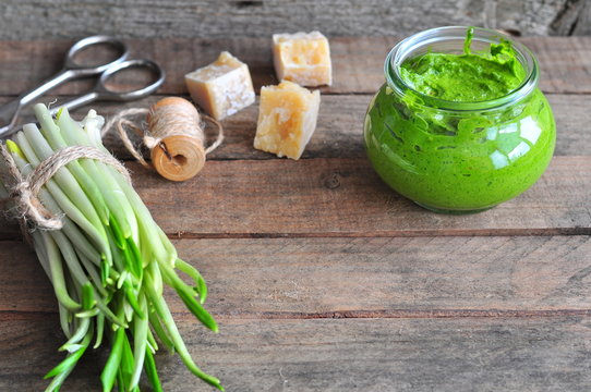 Ramson and sauce pesto on a wooden table