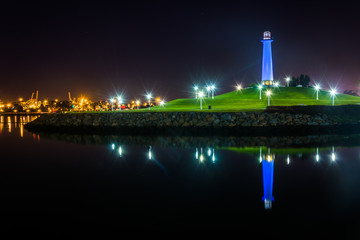 Fototapeta na wymiar Long Beach Harbor Lighthouse reflecting at night, in Long Beach,