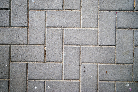 Fototapeta Textured background of grey bricks in a herringbone pattern