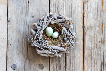 Easter eggs in nest on wood