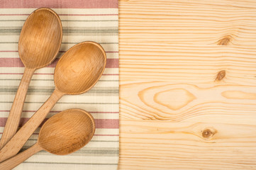 wooden spoon and dish cloth on wooden table