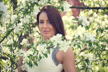 girl in flowers of apple tree