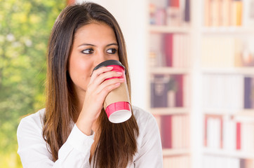 beautiful young girl drinking take away coffee