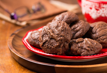 Homemade chocolate cookies on red plate