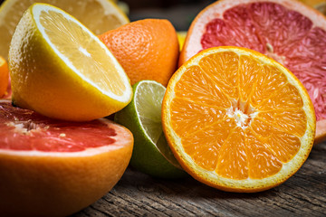 Fresh citrus fruits on rustic wooden  background, closeup