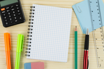 Office tools with blank notebook on wooden table