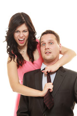 Woman pulling tie of man.