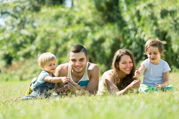 Family of four in sunny park