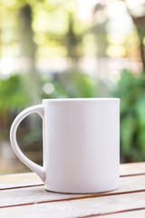 White coffee cup in garden