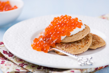 Buckwheat blini with red caviar and sour cream
