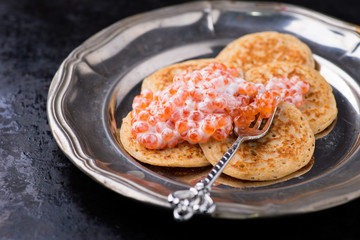 Buckwheat blini with red caviar and sour cream