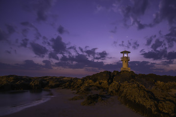 Lighthouse on rock after sunset at Thailand.