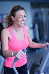 Fototapeta na wymiar woman exercising on treadmill in gym