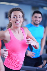 woman exercising on treadmill in gym