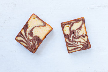 Chocolated and yellow butter marble cake on white background