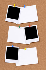 Vertical row or line of three blank polaroid style photo frame prints pinned to cork bulletin board...