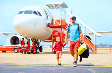 happy father and son after having a trip on airplane