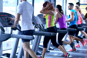 Fototapeta na wymiar Group of people running on treadmills
