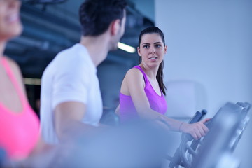 Group of people running on treadmills